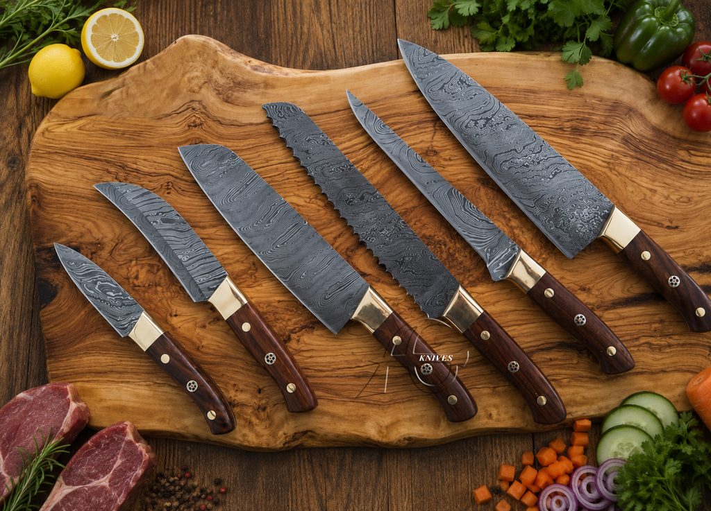 Six kitchen knives with patterned steel blades and dark brown wooden handles are arranged on a rustic wooden cutting board, surrounded by fresh vegetables, meat, and herbs.