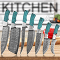 A 7-piece kitchen knife set with patterned steel blades and turquoise-colored handles, displayed on a wooden cutting board with a blurred kitchen background.
