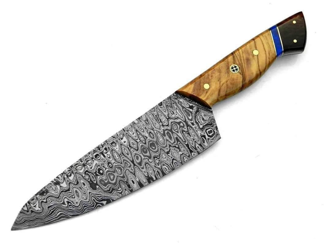 A chef's knife with a Damascus steel blade and a wooden handle with brass pins and a blue accent stripe, shown on a plain white background.