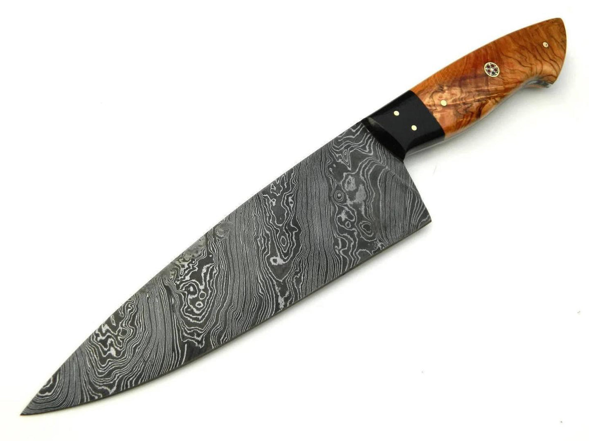 A chef's knife with a Damascus steel blade and a polished wood handle, shown diagonally on a plain white background.