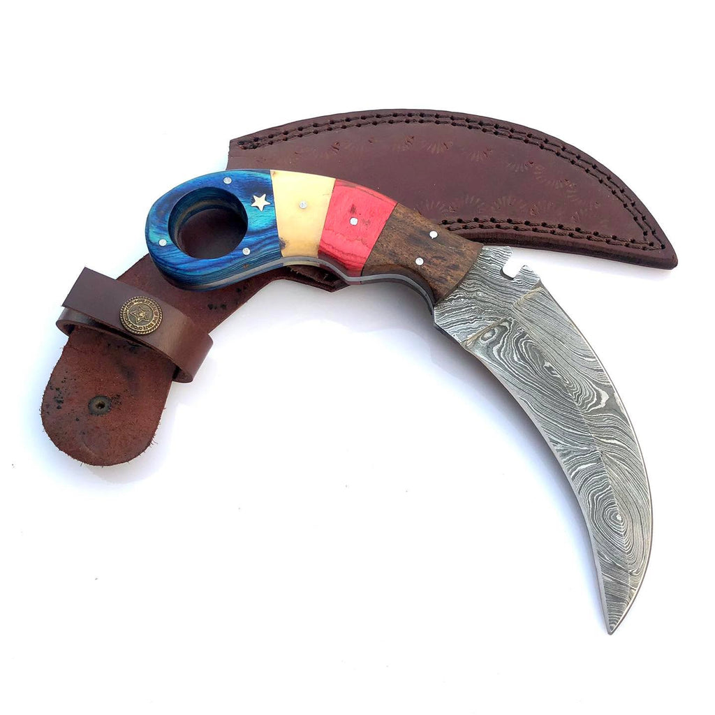 A curved Damascus steel knife with a colorful inlay handle, shown with its brown leather sheath on a white background.