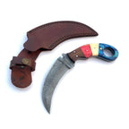 A curved Damascus steel knife with a colorful handle and a brown leather sheath, displayed on a clean white background.