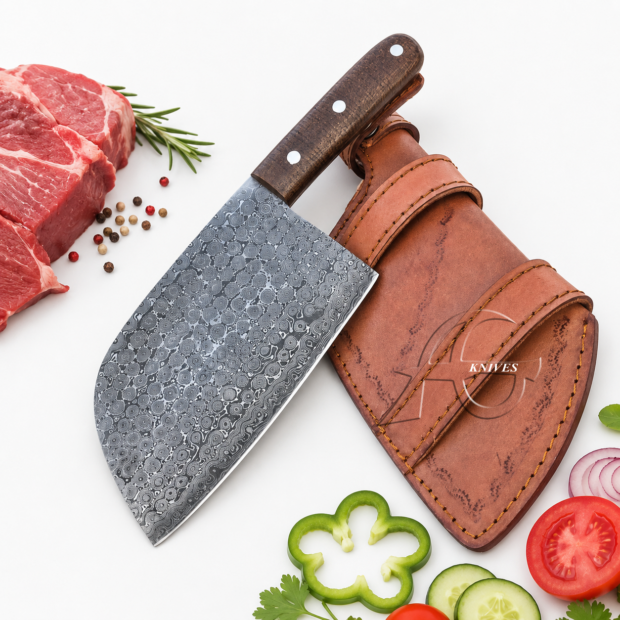 A cleaver-style kitchen knife with a hammered dark gray steel blade and a brown wooden handle, shown next to a brown leather sheath on a white background. Sliced raw beef, tomatoes, cucumbers, and herbs are arranged around it as styling props.