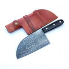 A Damascus steel kitchen knife with a black handle and silver patterned blade, shown next to its brown leather sheath on a white background.