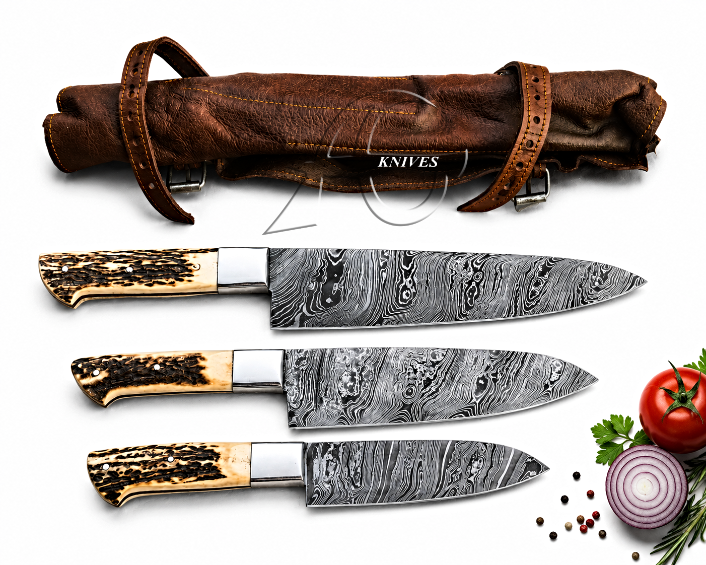 Three Damascus steel chef knives with patterned handles are displayed below a brown leather knife sheath on a white background, with small food props including a tomato, onion, peppercorns, and parsley at the bottom right.
