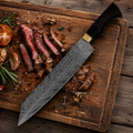 Decorative chef's knife on a wooden cutting board with sliced steak and vegetables.