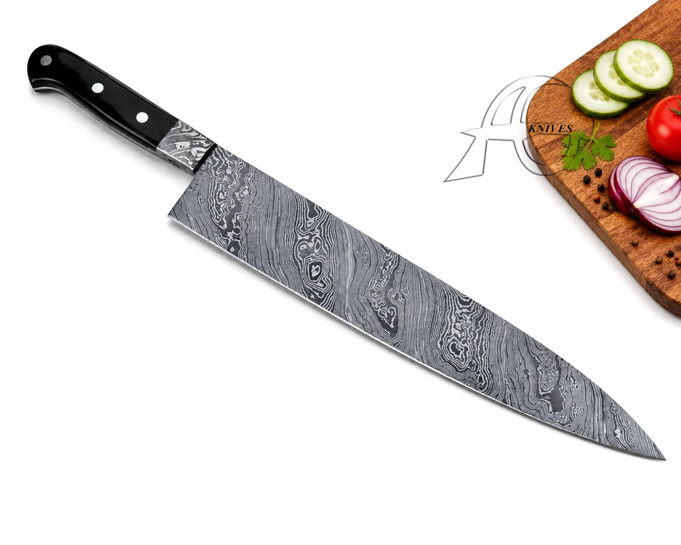 A chef's knife with a patterned Damascus steel blade and a black handle, shown diagonally on a white background with a wooden cutting board and sliced vegetables in the top right corner.