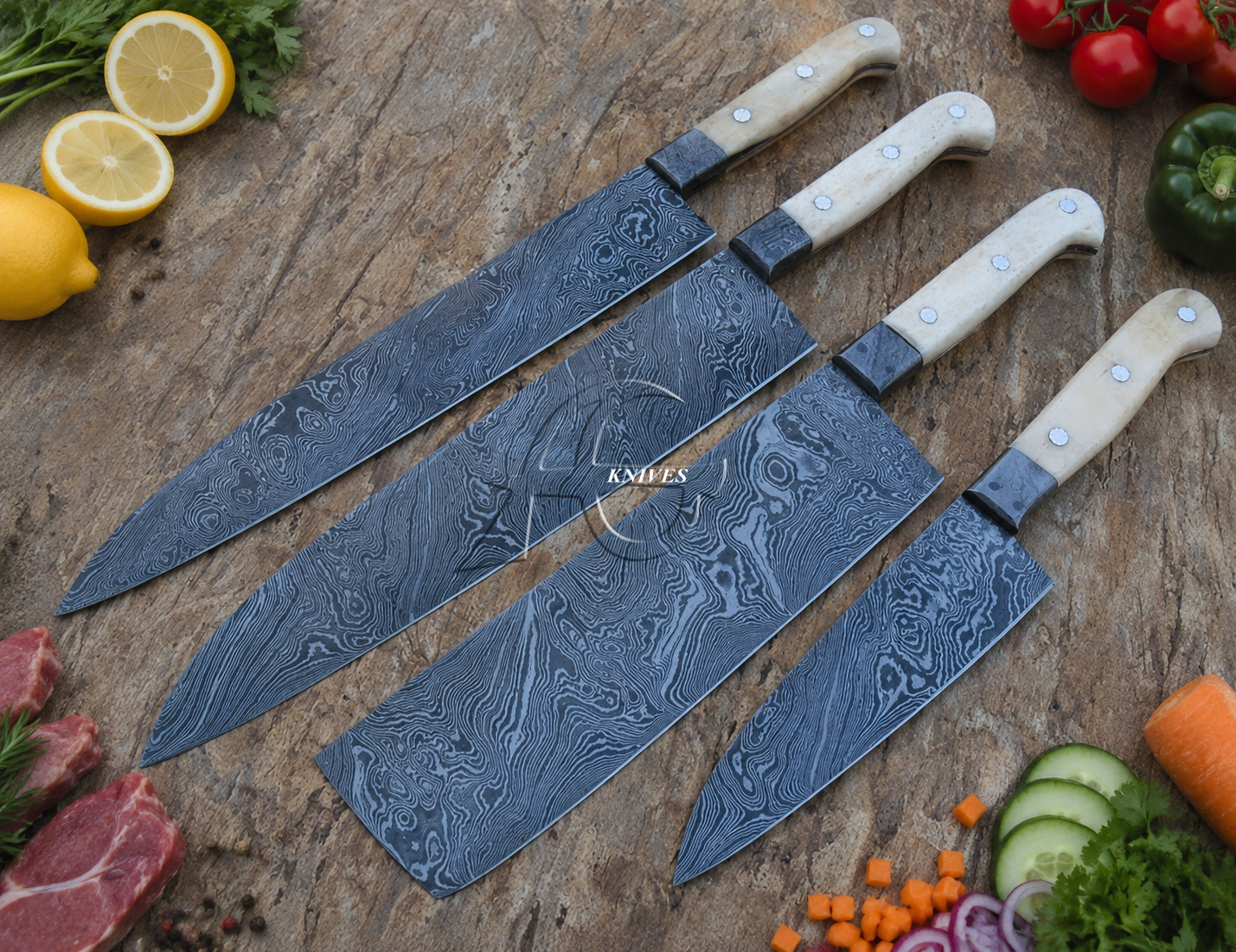 Four Damascus steel kitchen knives with cream-colored handles arranged diagonally on a rustic wooden table, surrounded by fresh ingredients like lemons, tomatoes, cucumber, carrots, and raw meat.