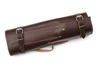 A dark brown leather cylindrical case with adjustable buckle straps and contrast stitching, shown on a plain white background.